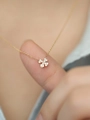 Macro shot of a sparkling four-leaf clover necklace pendant on a gold chain - 14K Gold Necklace (40+5cm)