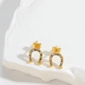 Detailed shot of gold horseshoe stud earrings set with colorful zircon on a stone base - Horseshoe (U-shaped ES2748-1)