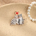 Detail of vintage cat brooch with rhinestones and red heart on a decorative plate - Heart Cat