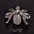 Sparkling silver bee brooch with clear rhinestones on textured black background - Silver Wing Rhinestone Bee