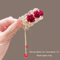 Detail of red rose hair claw with white pearls and long gold tassel fringe, 5cm diameter - M34 Red Rose