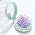 Portable mint green and purple folding hairbrush with integrated round makeup mirror - Light Green + Purple