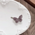 Detailed view of a purple rhinestone butterfly hair clip on a vintage ceramic tray - Single Butterfly / Purple