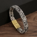 Macro shot of black and white braided leather bracelet with bronze magnetic clasp - Retro White