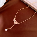 Detail of gold necklace with pink enamel cherry blossoms and elegant pearl pendant - Enamel Flower Style
