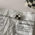 Detailed view of a round black and white checkered hair clip with a smooth glazed surface - 5# Mini Hair Claw - Round