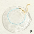Detail shot of light blue beaded bracelet with gold lobster clasp and extension chain - Blue