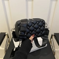 Quilted black crossbody bag with wide nylon strap and detachable pouch in minimalist setting - Black
