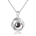 Silver projection necklace featuring spiral pendant with round black center stone - Rotating Circle Silver
