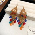 Detail shot of vintage Bohemian tassel earrings with colorful beads on a beige velvet surface - Colorful Round Water Drop Tassel (22#)