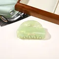 Detail of light green marble patterned hair claw clip with pearlescent resin finish - PVC 8cm Round Head - Iridescent Green