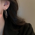 Close-up of minimalist silver hoop earrings worn by a model in a professional suit - Simple Glossy Large Hoop (62#)