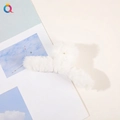 Large white faux fur plush claw clip for women's hairstyle shown on a white table - Plush Solid Color Claw - White