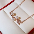 Close-up of rose gold rose petal pendant with white pearls and sparkling zircons - Rose Gold
