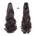 Detail view of wavy claw clip ponytail extension in dark brown shade 2 showing texture - Dark Brown