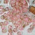 Detailed macro view of 10mm pink and gold cracked pattern glass beads for jewelry making - Butterfly Flower