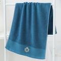 Thick navy blue cotton towel with elegant gold crown embroidery on a minimal white stand - Cotton Crown Blue (Towel)