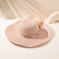 Detail of a wide-brim straw hat with pearl flowers and a large bow in soft pink - M (56-58cm) / Pink
