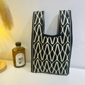 Chic knitted wrist bag featuring a bold black and beige wave geometric pattern - Wavy Diamond Black