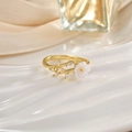 Macro shot of gold tulip ring with cat's eye stone flower and shimmering crystal leaf detail - White Flower Leaf Mother Of Pearl Look (JZ0123)