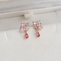 Macro shot of rose gold butterfly earrings with pink stones and red teardrop pendants - |7# 24917a