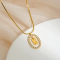 Close-up of gold snake chain necklace with Z letter pendant and crystal oval frame - Letter Z