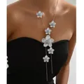 Detail of silver long tassel necklace with floral pendants on a black dress - Silver Flower