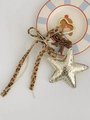 Khaki headphone charm with silver star pendant and leopard print ribbon bow - Gold Star Charm