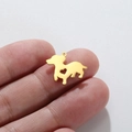 Golden heart puppy pendant charm for DIY jewelry making shown on finger scale - Gold