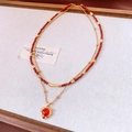 Detail einer Vintage-Doppelhalskette mit roten Perlen und 18k Gold-Herzanhänger - Gold-Rot (18K Vergoldet)