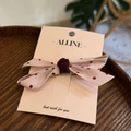 Detailed close-up of pink polka dot fabric hair bow on a branded card presentation - Light Pink Polka Dot Side Clip / Light Pink
