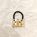 Golden hollow star metal hair ring with black elastic band on white background - Gold Hollow Star Rectangle 5cm