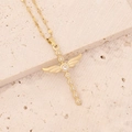 Detail shot of a gold winged cross necklace with zircons on a textured stone surface - Cross with Wings (Large) / White