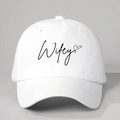 Close-up of Wifey embroidery and black heart on a white cotton twill baseball cap - White