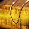 Close-up of minimalist golden titanium steel box chain necklace with smooth finish - Box Chain / Elegant Gold