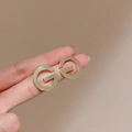Macro shot of gold letter G stud earrings showing brushed metal texture and polished finish - 31# Gold Double G Letter Studs (31# Silver Earring Post-Gold-Letter)