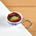 Miniature blue and white porcelain bowl keychain featuring realistic spicy fish stew - Fish Head with Chopped Chili