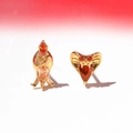 Detail of cobra stud earrings featuring sparkling red and champagne zircon inlay - Cobra Snake Head