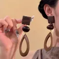 Detailed view of vintage ethnic wooden geometric dangle earrings with hollow drop pendant - 35# 925 Sterling Silver Earring Post - Coffee - Geometric Wood Splicing Dangle