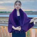 Close-up of purple knit shawl featuring a faux fur collar and decorative fringe trim - Purple