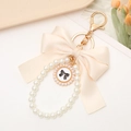 Elegant pearl bow keychain with number 5 pendant for phone cases and headphones - White