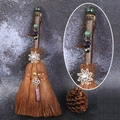Detailed close-up of a witch broom with natural crystals, pine cones, and metal charms - Sparrow Stone