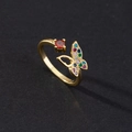 Macro shot of an open butterfly ring featuring colorful zircon pavé and a red stone - Style F-Gold Colorful Zircon Butterfly