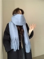 Blue mohair style winter scarf with fringe tassels worn by a female model - Light Blue