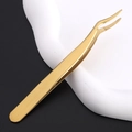 Close-up of golden curved stainless steel tweezers for eyelash extension application - Gold