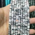 Macro shot of natural stone spacer beads with unique zebra patterns for jewelry making - Hawk Eye Stone