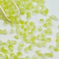 Macro shot of pale yellow lily of the valley glass flower beads on a wooden scoop - Lily of the Valley 4# Olive Green 7x12mm