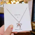 Silberne Schleifen-Halskette mit quadratischem rosa Kristallanhänger und Glitzer - Silber Rosa Schleife Zirkon