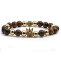 Macro detail of crown bead with black zircons on brown tiger eye stone bracelet - Yellow Tiger Eye Gold