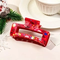 Red festive Happy New Year claw clip with star and heart prints on a cozy background - Red